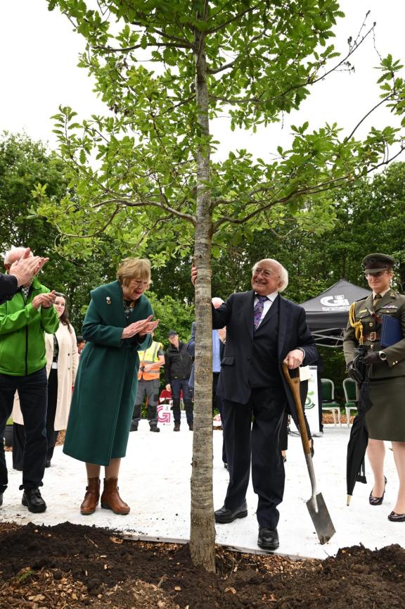 President Higgins after planting a new tree, with Sabina Higgins also pictured