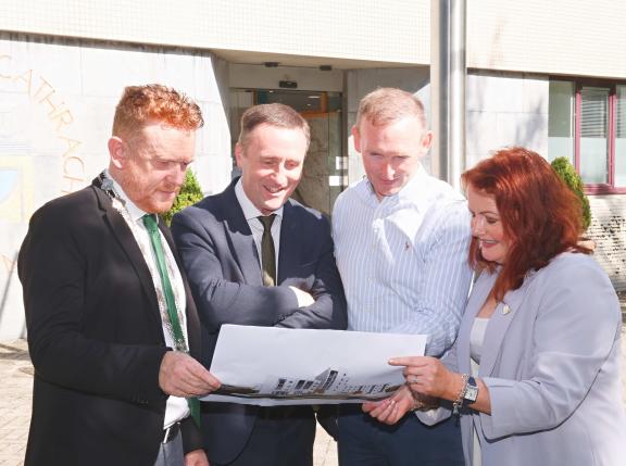 Staff looking at 3d image of design project