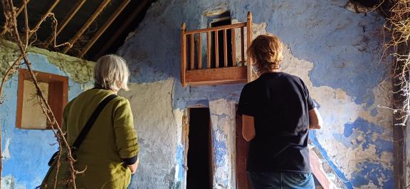 Two people looking at old building