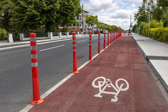 An image showing bollards and a red painted cycle lane along Doughiska Road South