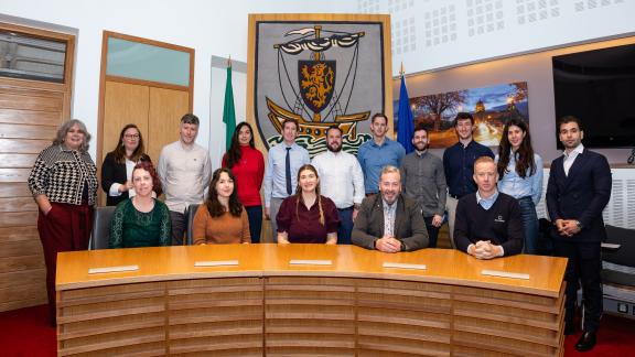 People involved in project lined up for pic in council chamber