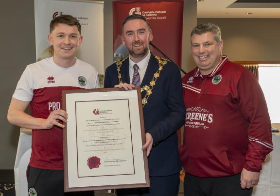 Mayor presenting certificate to two gentlemen