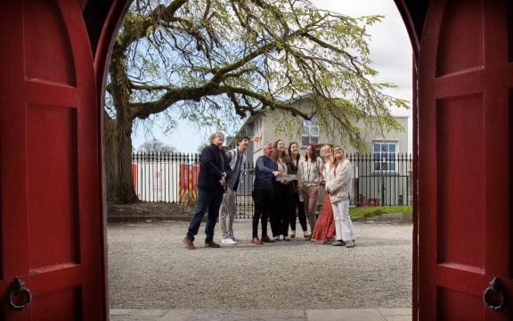 Group of people looking at Wonder Wander trail map outside St. Nicholas' Church