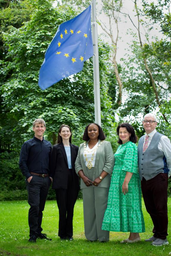 GCC Staff standing outside city hall with eu flag raised