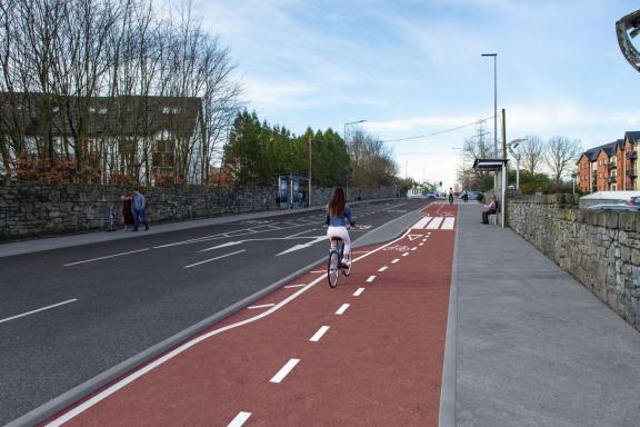 A photomontage image showing part of the future Monivea Road (East) Active Travel Scheme.  This image shows a woman cycling on the proposed new cycle lane.  Two bus shelters can also be seen on opposite sides of the road.