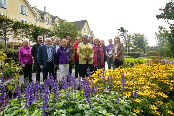 Reps at new memorial garden, flowers in the foreground