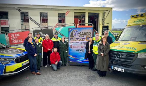 Staff safety partnership, an garda síochána, and ambulance services standing outside a garda car and ambulance