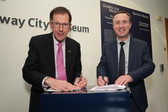 professor of university and ce of city council signing a new strategic partnership at Galway City Museum