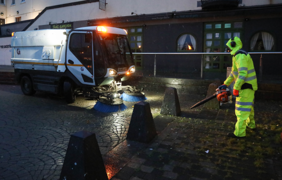 Staff in high vis and street sweeper in the snowy weather at Spanish Arch