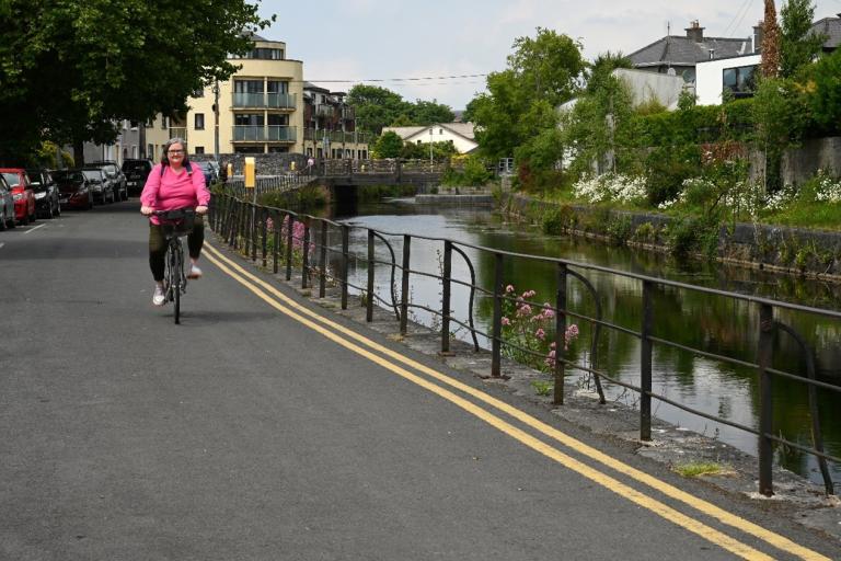 A woman cycling along Eglinton Canal.