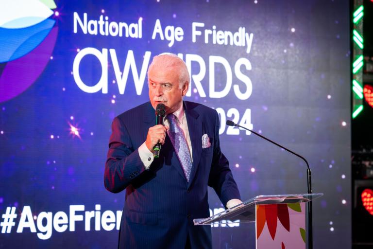 Man talking into microphone at National Age Friendly Awards 