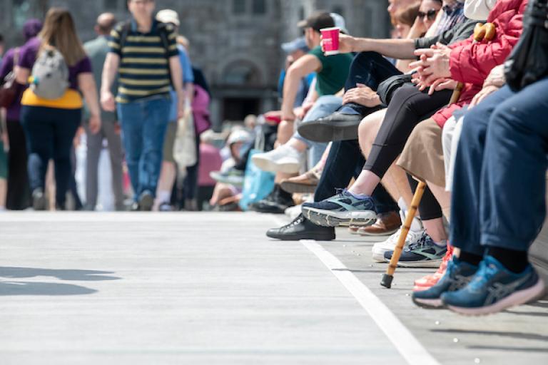 A view of people walking and sitting at Droichead an Dóchais