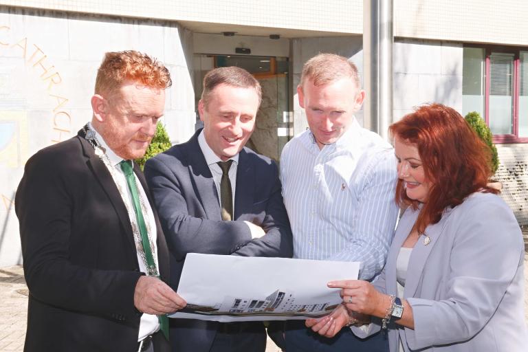 Staff looking at 3d image of design project