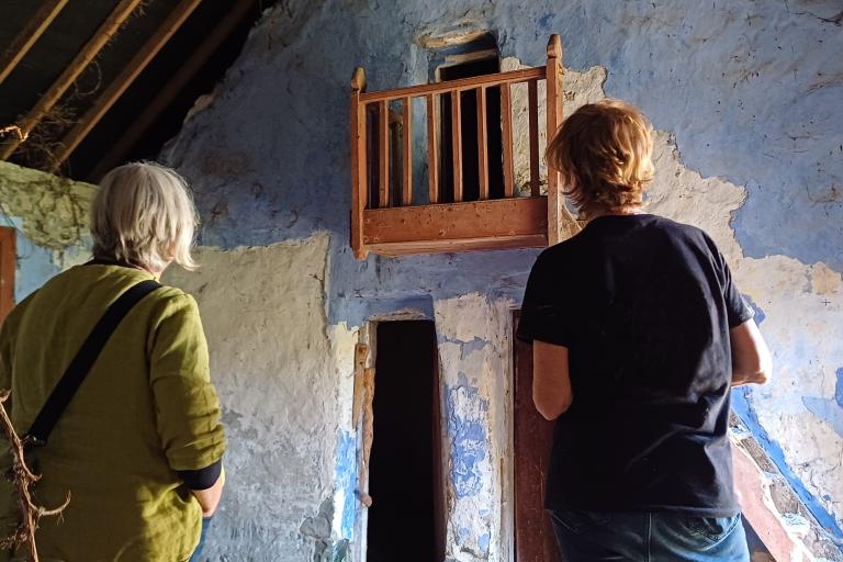 Two people looking at old building