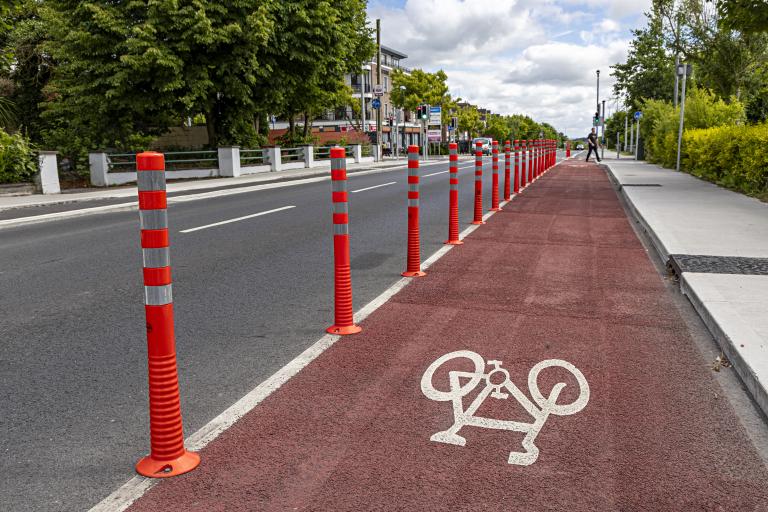 An image showing bollards and a red painted cycle lane along Doughiska Road South