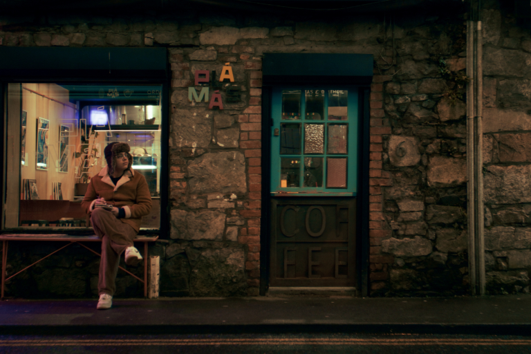 Young man sitting outside coffee shop