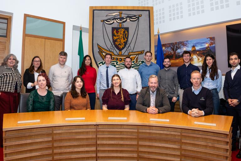 People involved in project lined up for pic in council chamber