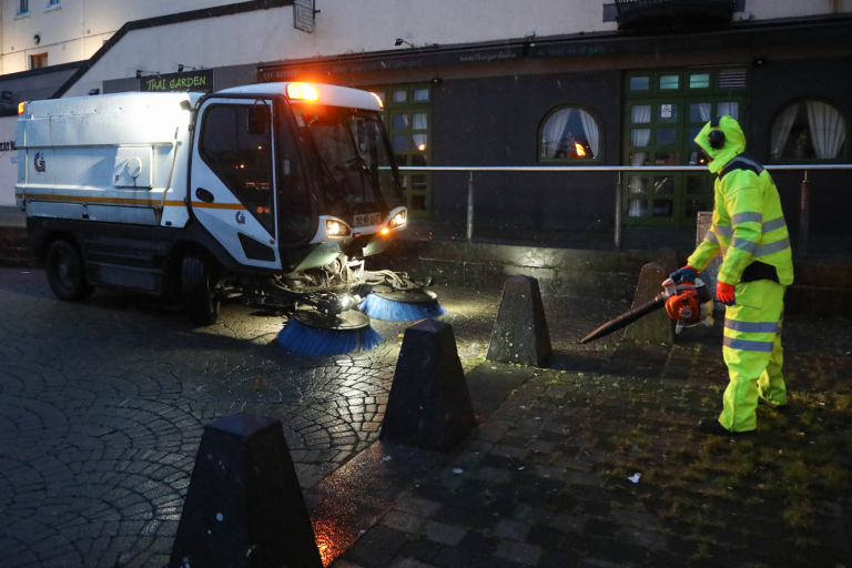 Staff in high vis and street sweeper in the snowy weather at Spanish Arch
