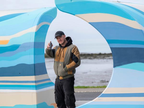 Local artists with the murals he painted