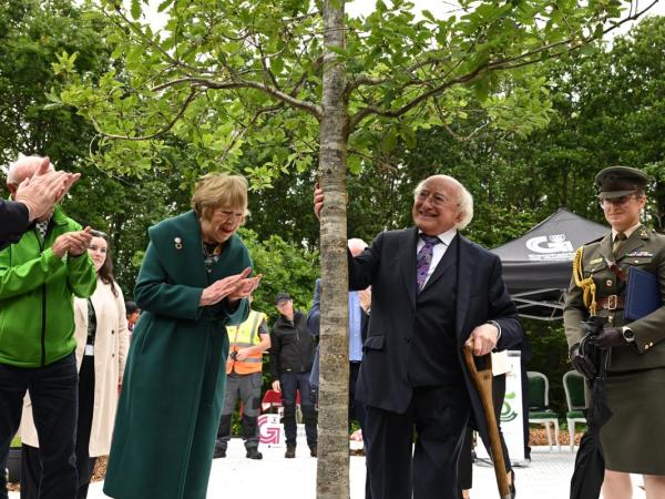 President Higgins after planting a new tree, with Sabina Higgins also pictured