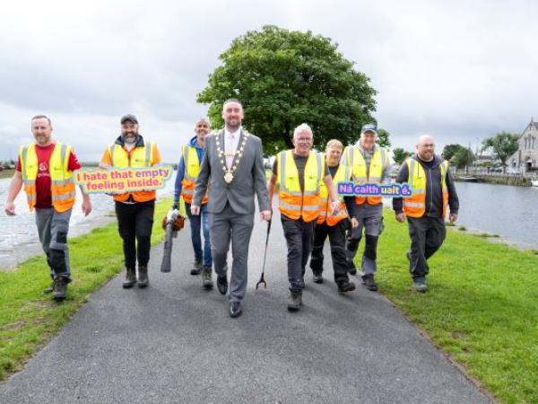 Staff from the LItter Management Unit walking in a line with Mayor Mike Cubbard, at the Claddagh Basin