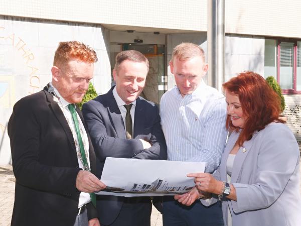 Staff looking at 3d image of design project