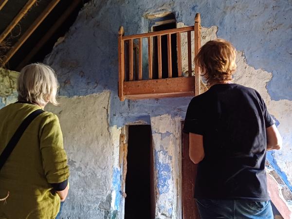 Two people looking at old building