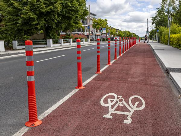 An image showing bollards and a red painted cycle lane along Doughiska Road South