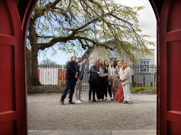 Group of people looking at Wonder Wander trail map outside St. Nicholas' Church