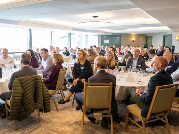 People in room listening to a talk