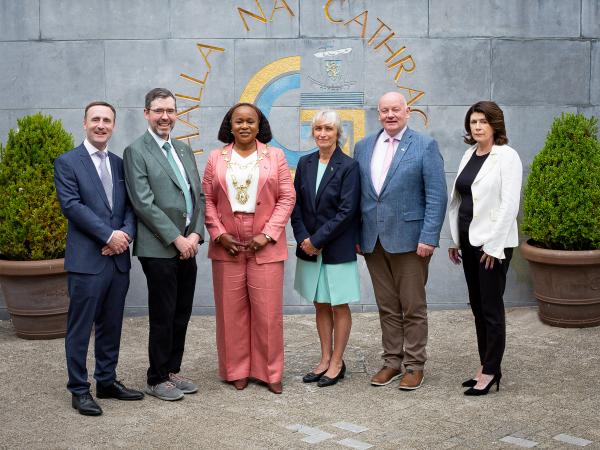staff and delegation posing for pic outside city hall