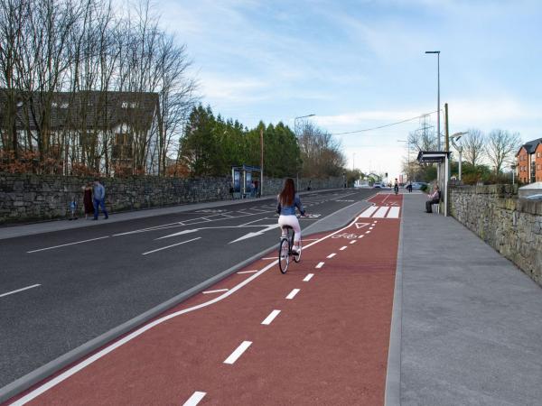 A photomontage image showing part of the future Monivea Road (East) Active Travel Scheme.  This image shows a woman cycling on the proposed new cycle lane.  Two bus shelters can also be seen on opposite sides of the road.