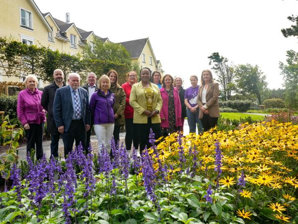 Reps at new memorial garden, flowers in the foreground