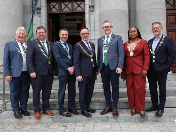mayors standing with their chains outside a building