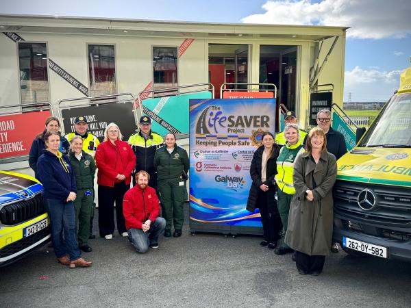 Staff safety partnership, an garda síochána, and ambulance services standing outside a garda car and ambulance