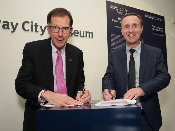 professor of university and ce of city council signing a new strategic partnership at Galway City Museum