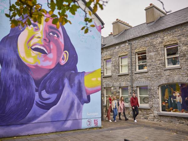 mural of woman and shop in galway
