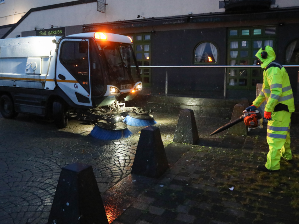 Staff in high vis and street sweeper in the snowy weather at Spanish Arch